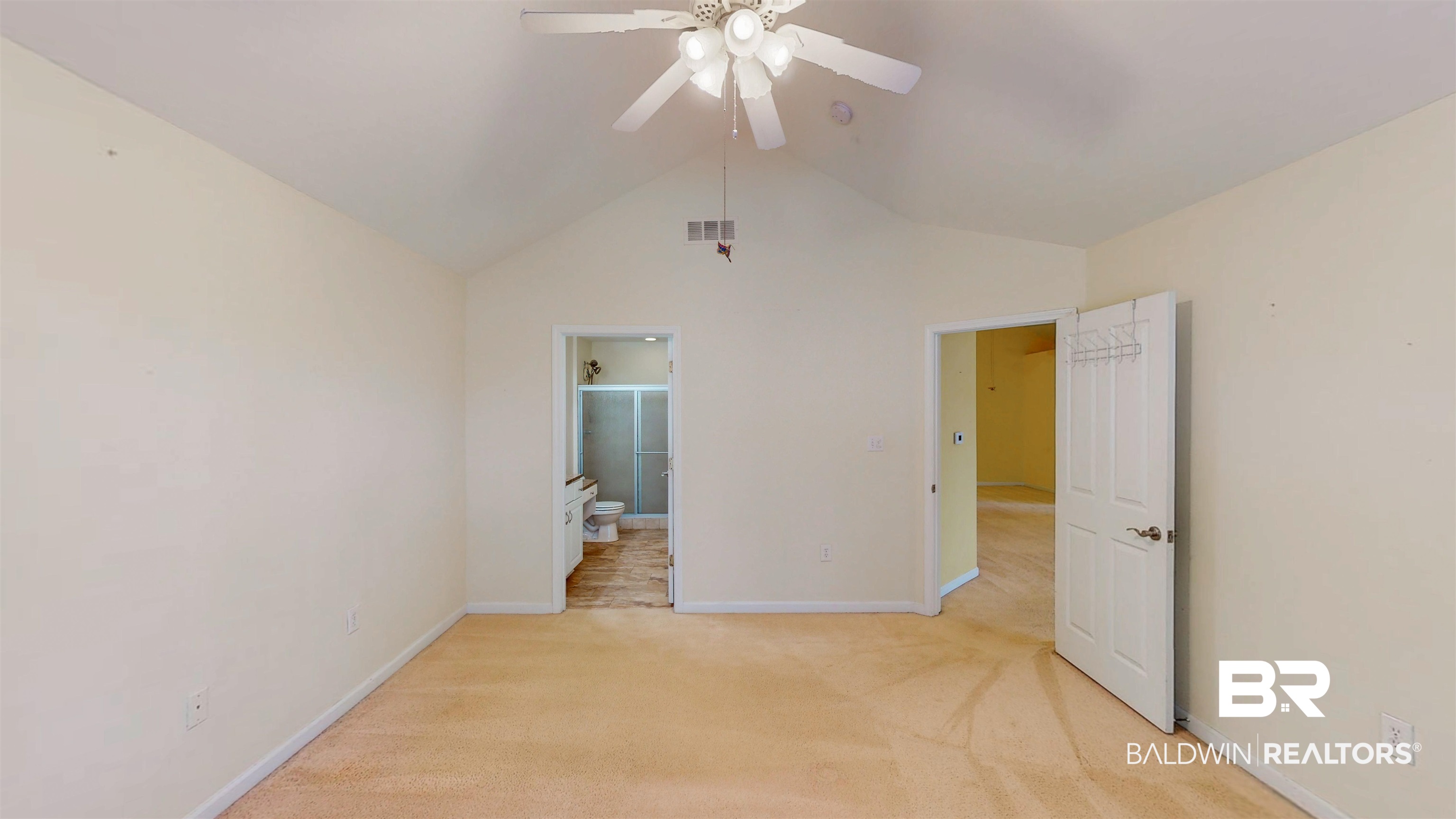303 Wyld Palms Drive, Unit 303 Foley, AL 36535 - Photo 14 of 36 Unfurnished bedroom with lofted ceiling, light carpet, a ceiling fan, and ensuite bath