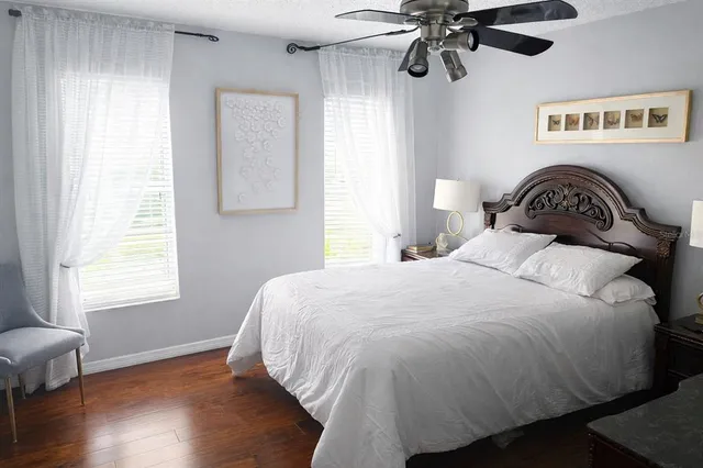 a bathroom with a granite countertop sink a toilet and a mirror