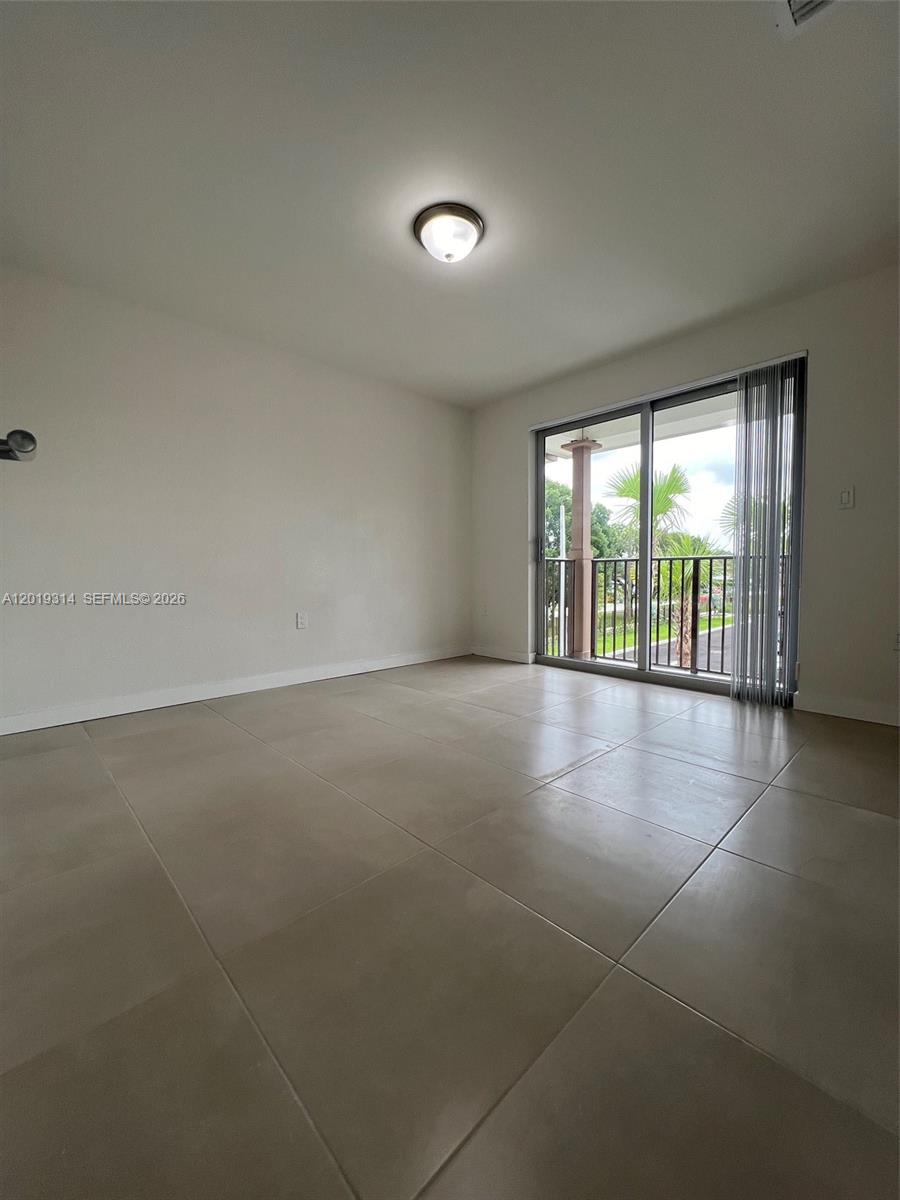 199 Redland Road, Unit B5 Florida City, FL 33034 - Photo 11 of 15 wooden floor in an empty room with a window