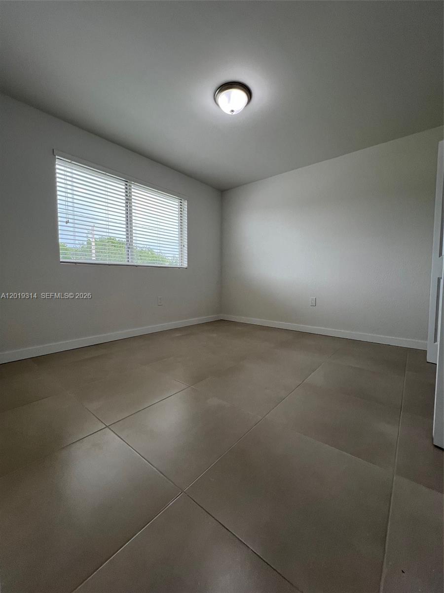 199 Redland Road, Unit B5 Florida City, FL 33034 - Photo 14 of 15 an empty room with a empty space and windows