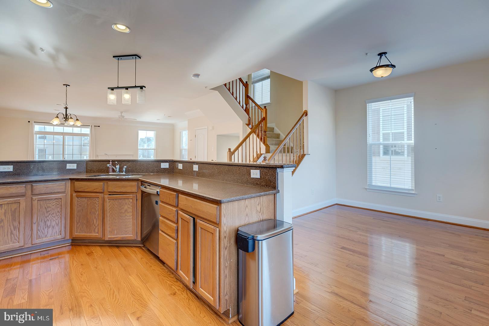 1010 Verdigris Way Odenton, MD 21113 - Photo 13 of 38 a kitchen with a sink cabinets and wooden floor