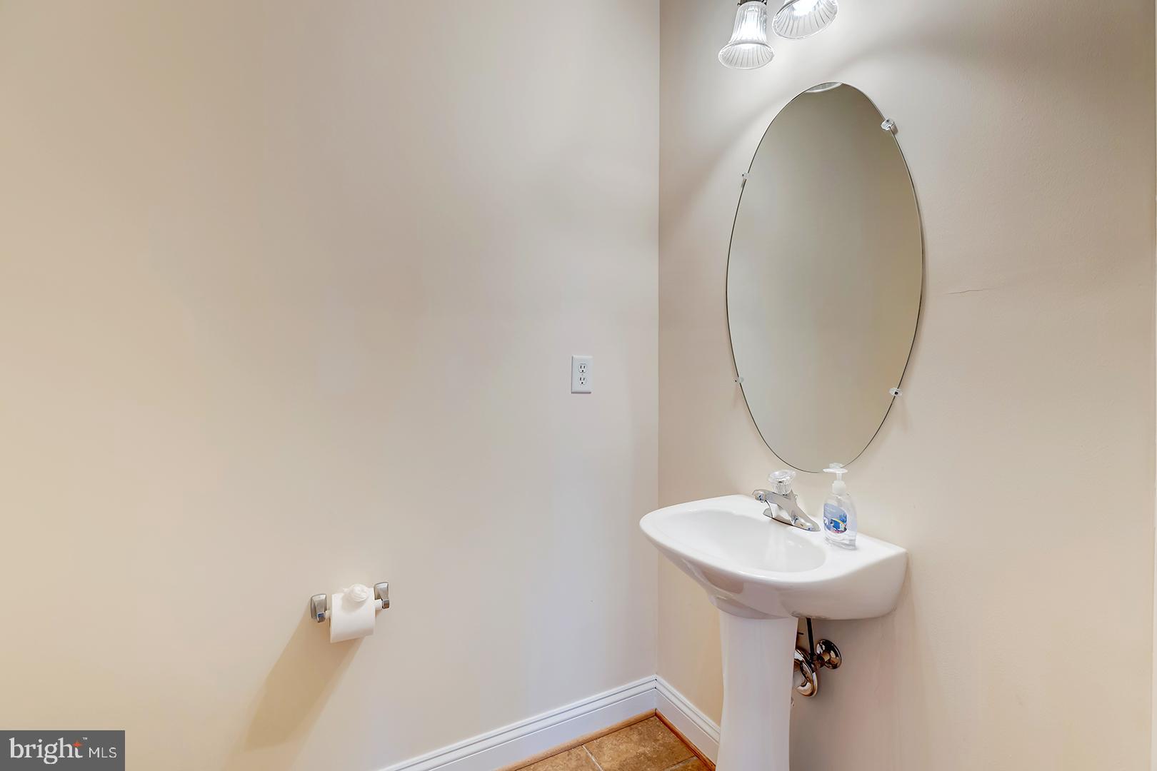 1010 Verdigris Way Odenton, MD 21113 - Photo 17 of 38 a bathroom with a sink a mirror and vanity