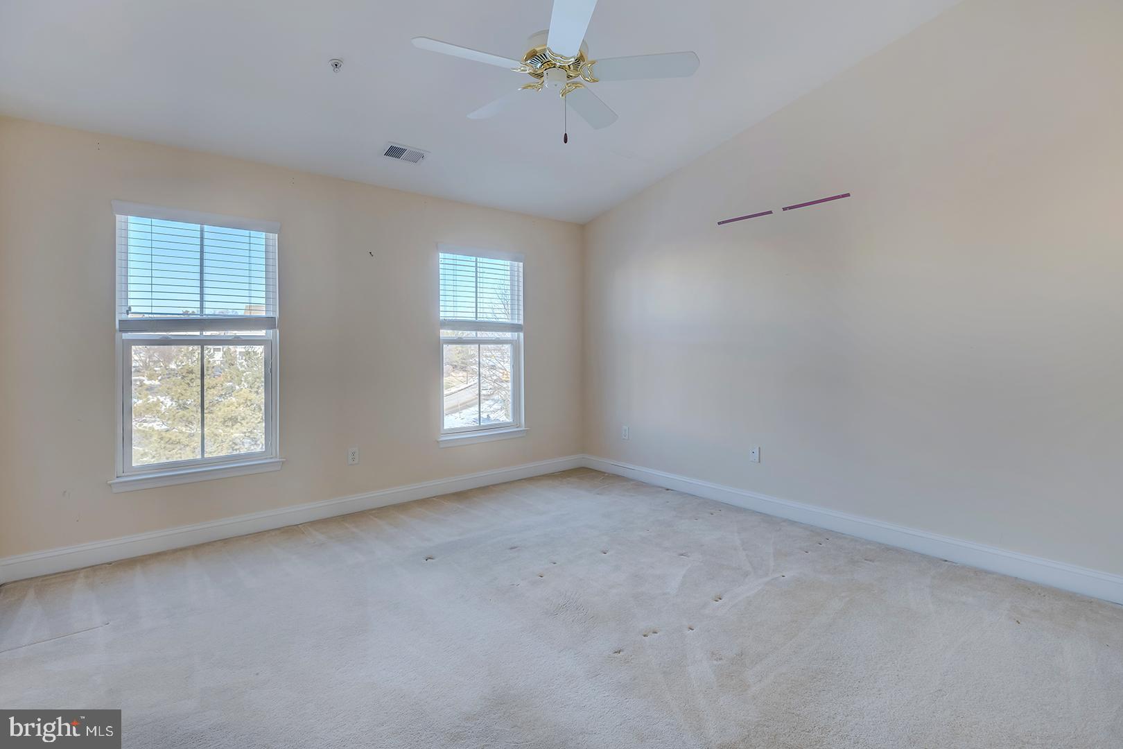 1010 Verdigris Way Odenton, MD 21113 - Photo 24 of 38 an empty room with windows and chandelier fan