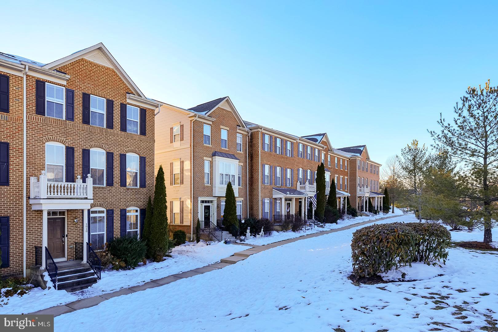 1010 Verdigris Way Odenton, MD 21113 - Photo 35 of 38 a street view along a residential apartment building with a yard