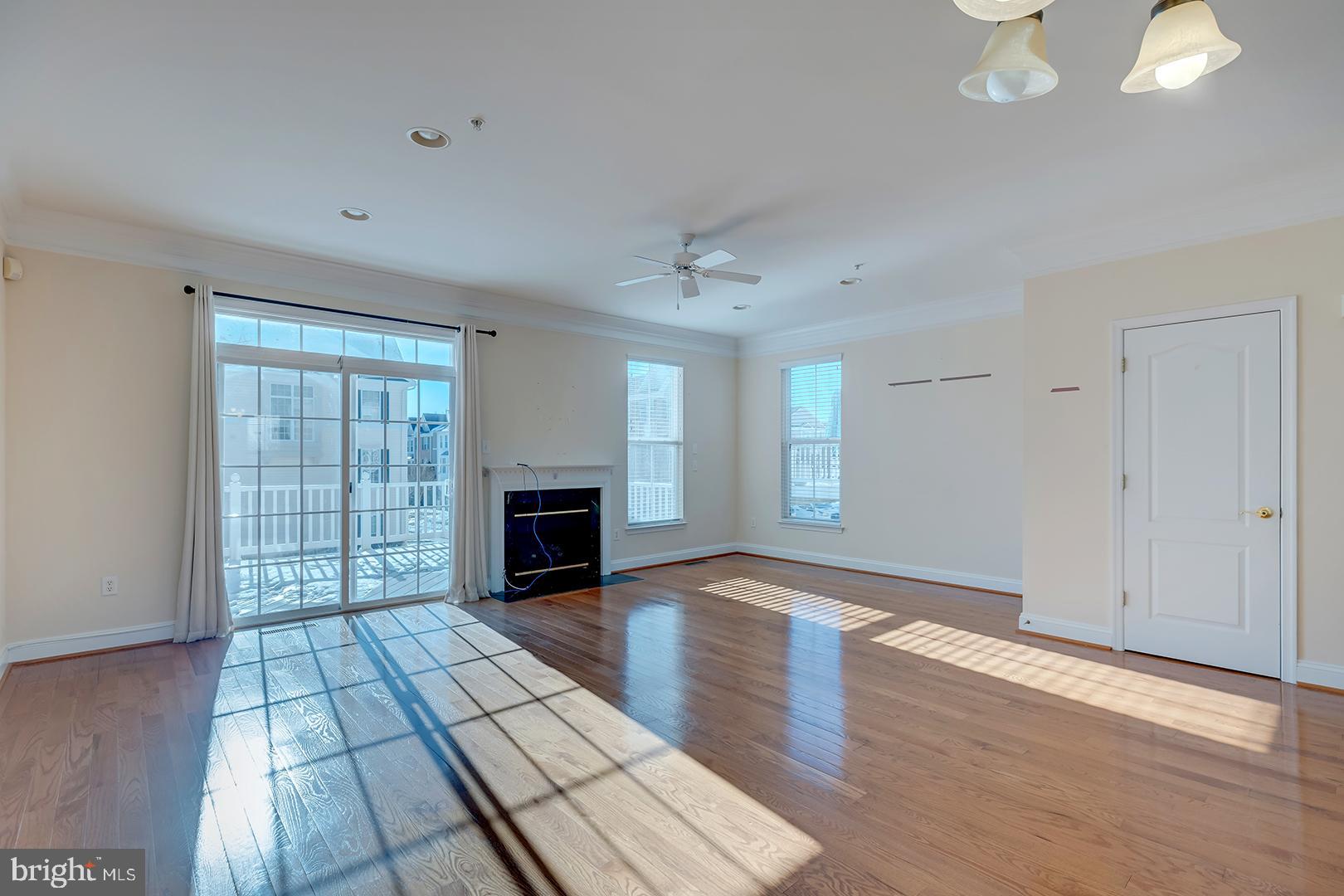 1010 Verdigris Way Odenton, MD 21113 - Photo 4 of 38 wooden floor fireplace and windows in an empty room