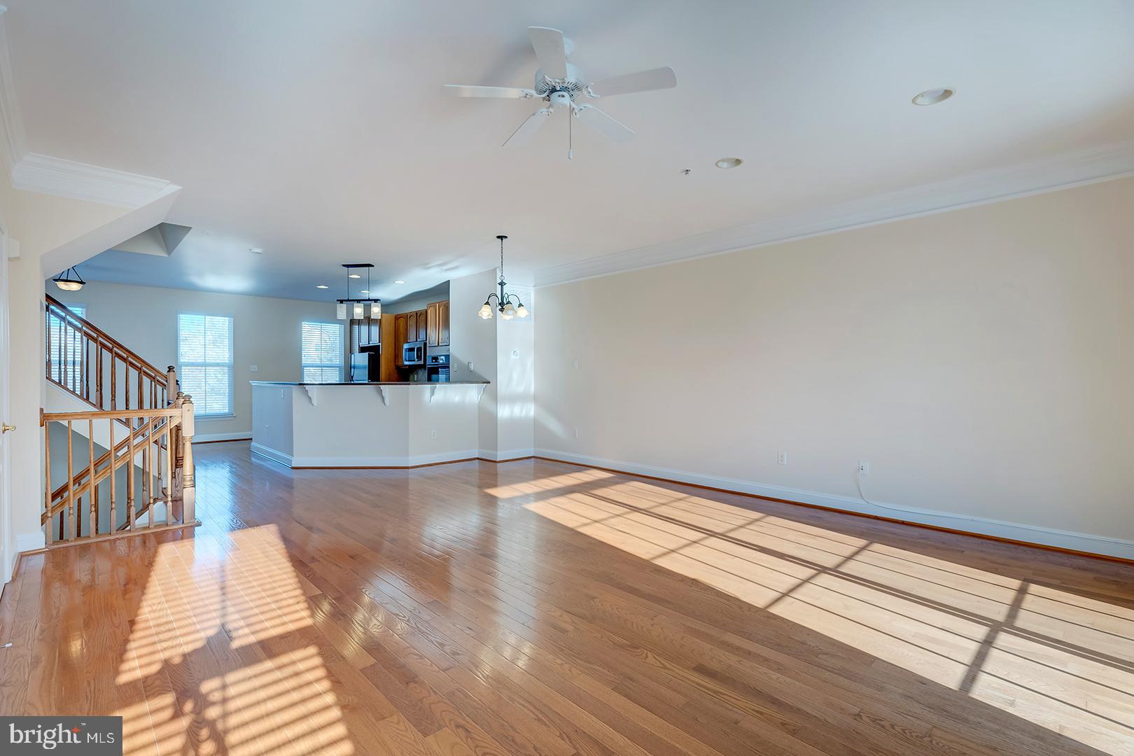 1010 Verdigris Way Odenton, MD 21113 - Photo 6 of 38 a view of a livingroom with wooden floor and a ceiling fan