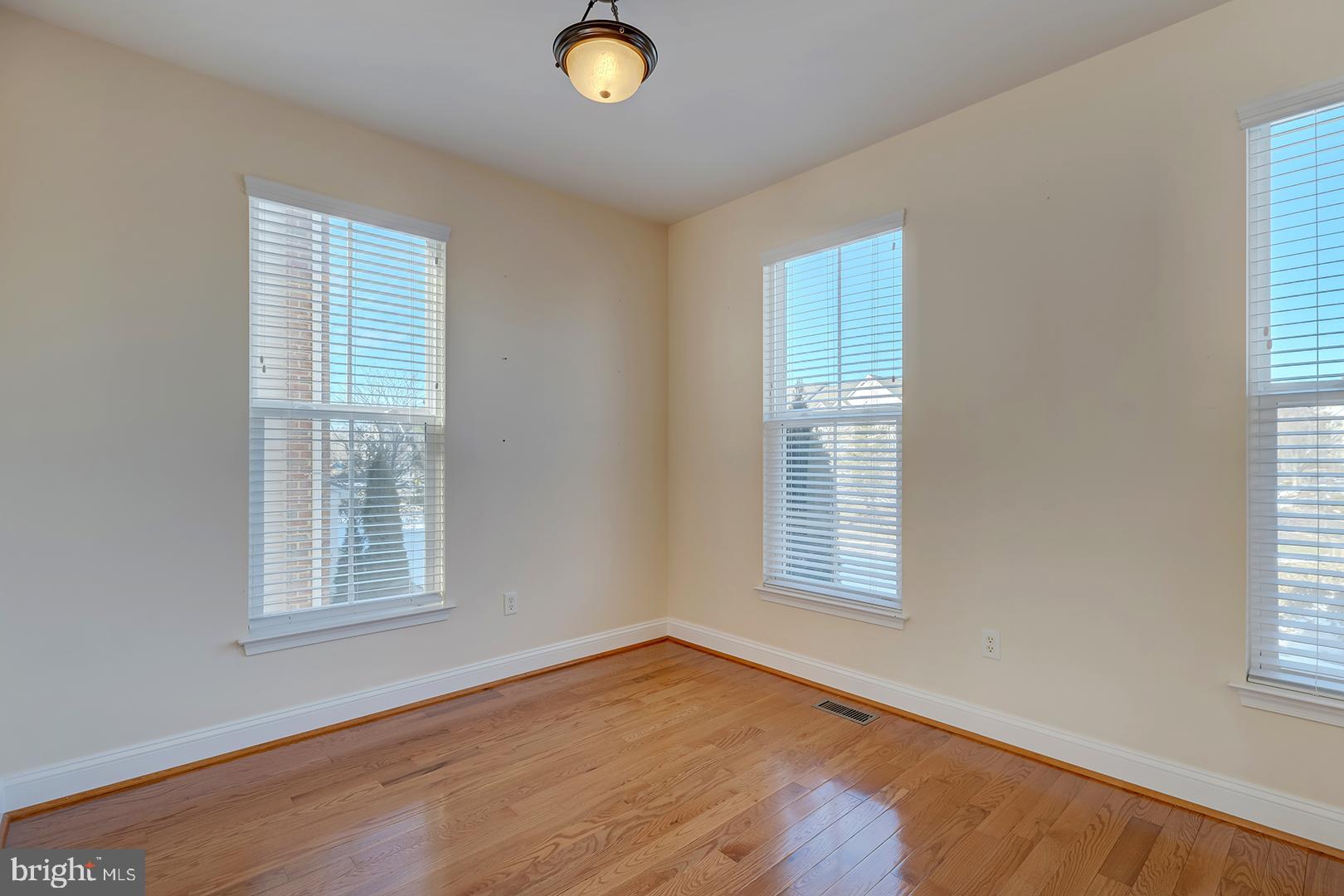 1010 Verdigris Way Odenton, MD 21113 - Photo 7 of 38 a view of an empty room with wooden floor and a window
