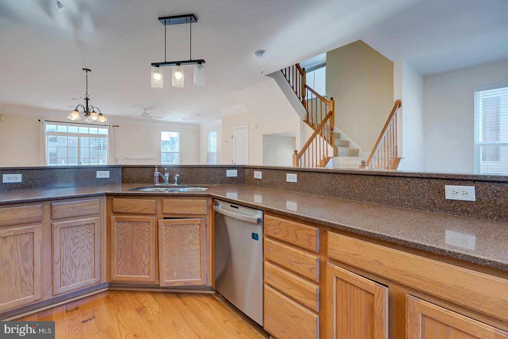 1010 Verdigris Way Odenton, MD 21113 - Photo 10 of 38 a kitchen with a sink cabinets and wooden floor