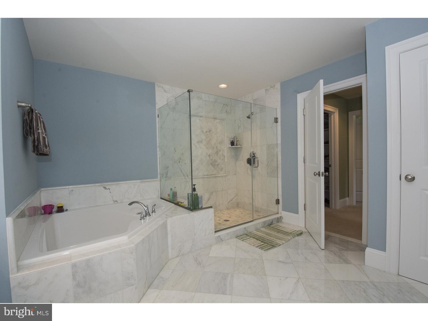 427 Iven Avenue Wayne, PA 19087 - Photo 15 of 24 a bathroom with a bathtub and a shower