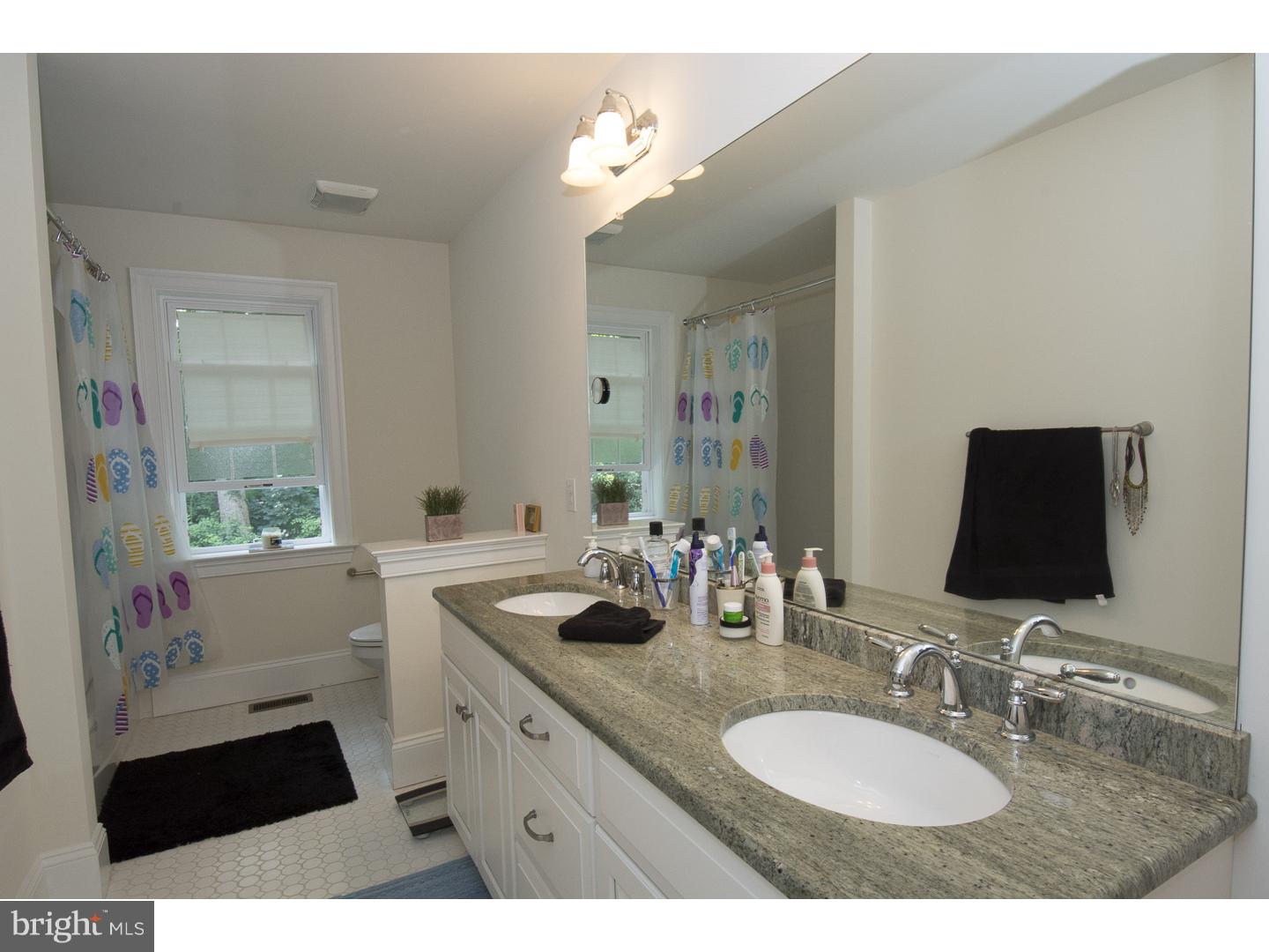 427 Iven Avenue Wayne, PA 19087 - Photo 19 of 24 a bathroom with a sink double vanity granite and a mirror