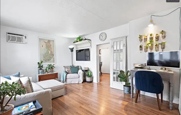 a living room with furniture and a flat screen tv