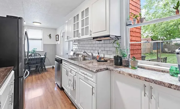 a kitchen with stainless steel appliances granite countertop a stove a sink and a refrigerator
