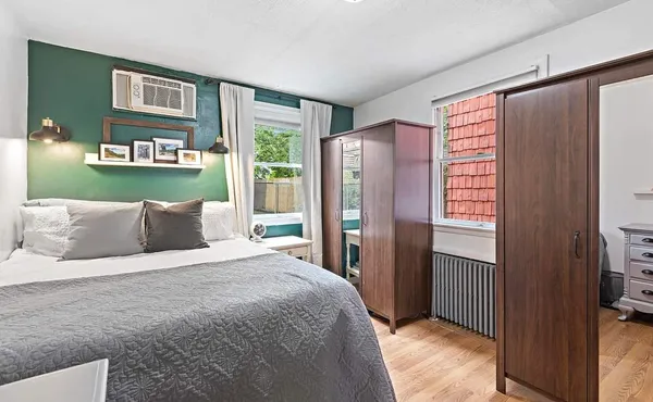 a bedroom with a bed and a large window
