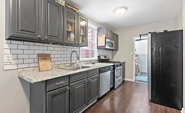 a kitchen with a sink stove and refrigerator