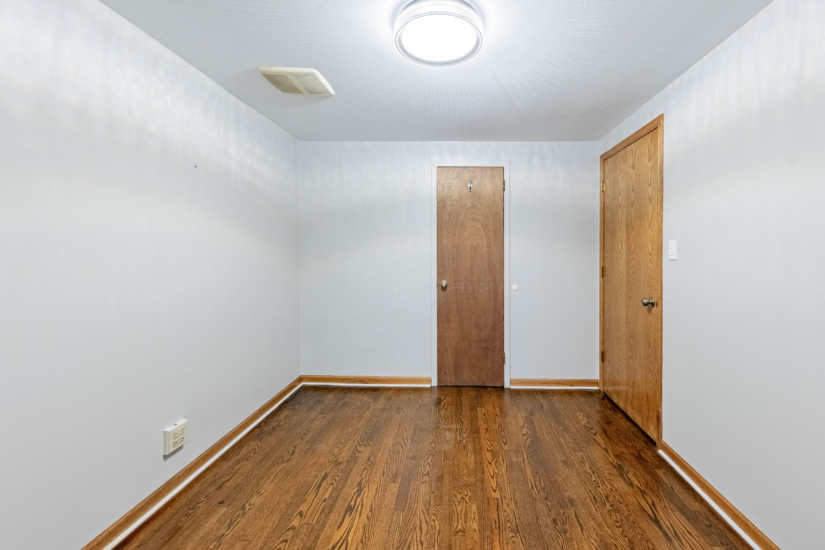 8912 South Ryan Road Hometown, IL 60456 - Photo 16 of 23 an empty room with wooden floor and windows