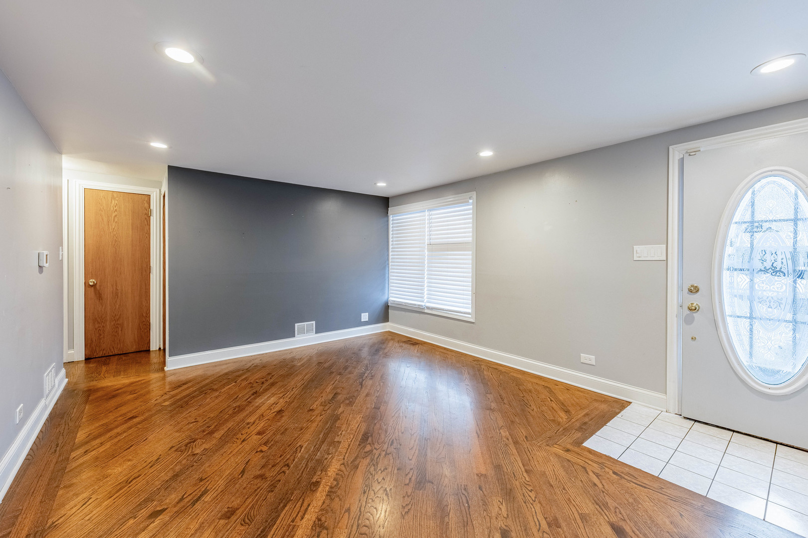 8912 South Ryan Road Hometown, IL 60456 - Photo 2 of 23 an empty room with wooden floor and windows