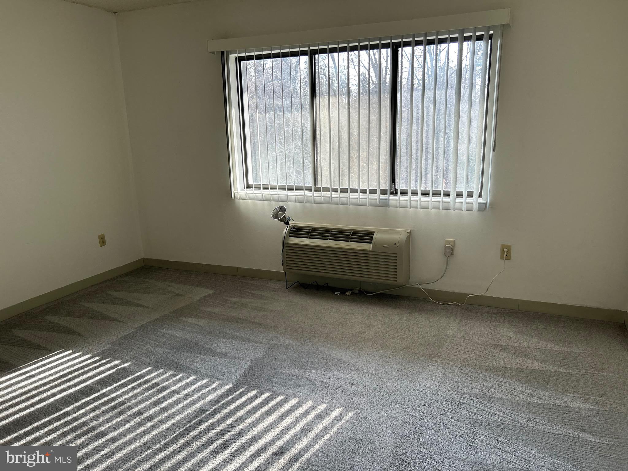 800 Avondale Road, Unit 7M Wallingford, PA 19086 - Photo 5 of 14 a view of a room with wooden floor and a window