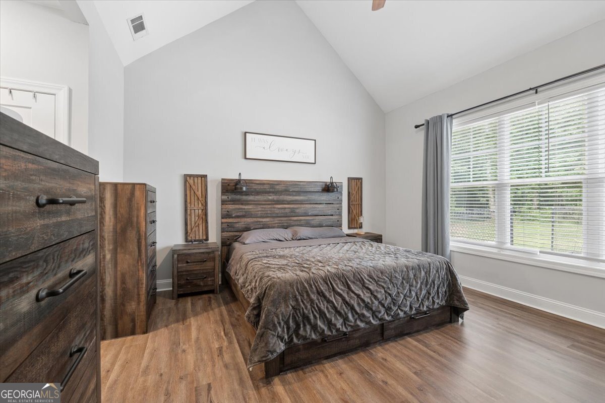 683 Teagle Road Forsyth, GA 31029 - Photo 24 of 50 a bedroom with a bed and a flat tv screen on the dresser