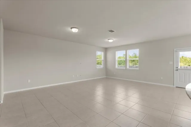 an empty room with windows and entrance