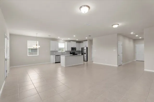 a large kitchen with stainless steel appliances granite countertop a large counter top and a stove top oven