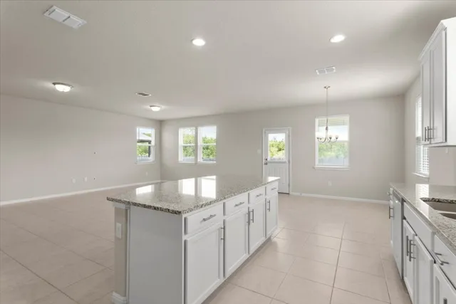 a large kitchen with stainless steel appliances granite countertop a large counter top and a stove top oven
