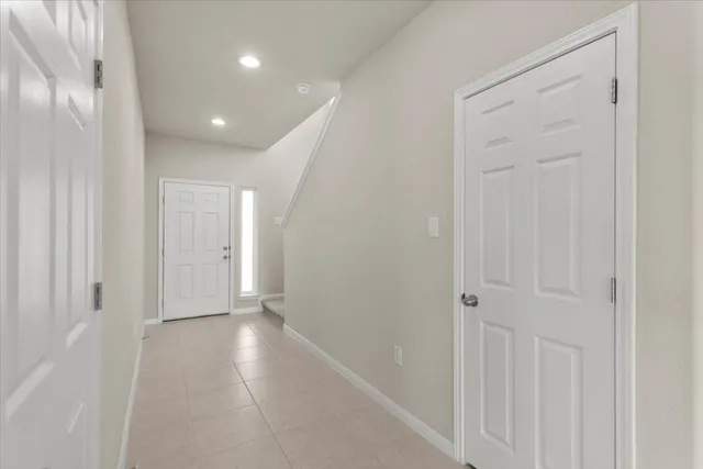 wooden floor with windows and chandelier