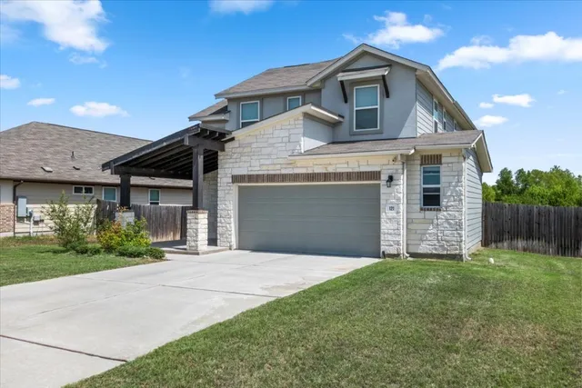a front view of a house with a yard and garage