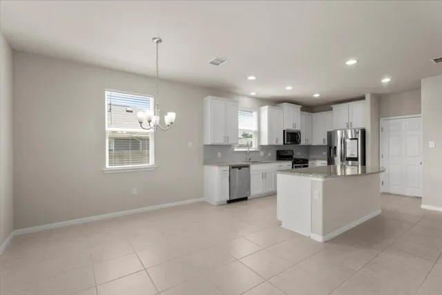 a kitchen with stainless steel appliances a refrigerator sink and microwave