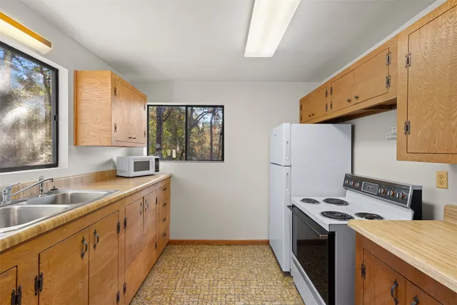 a hallway with a bed and a window