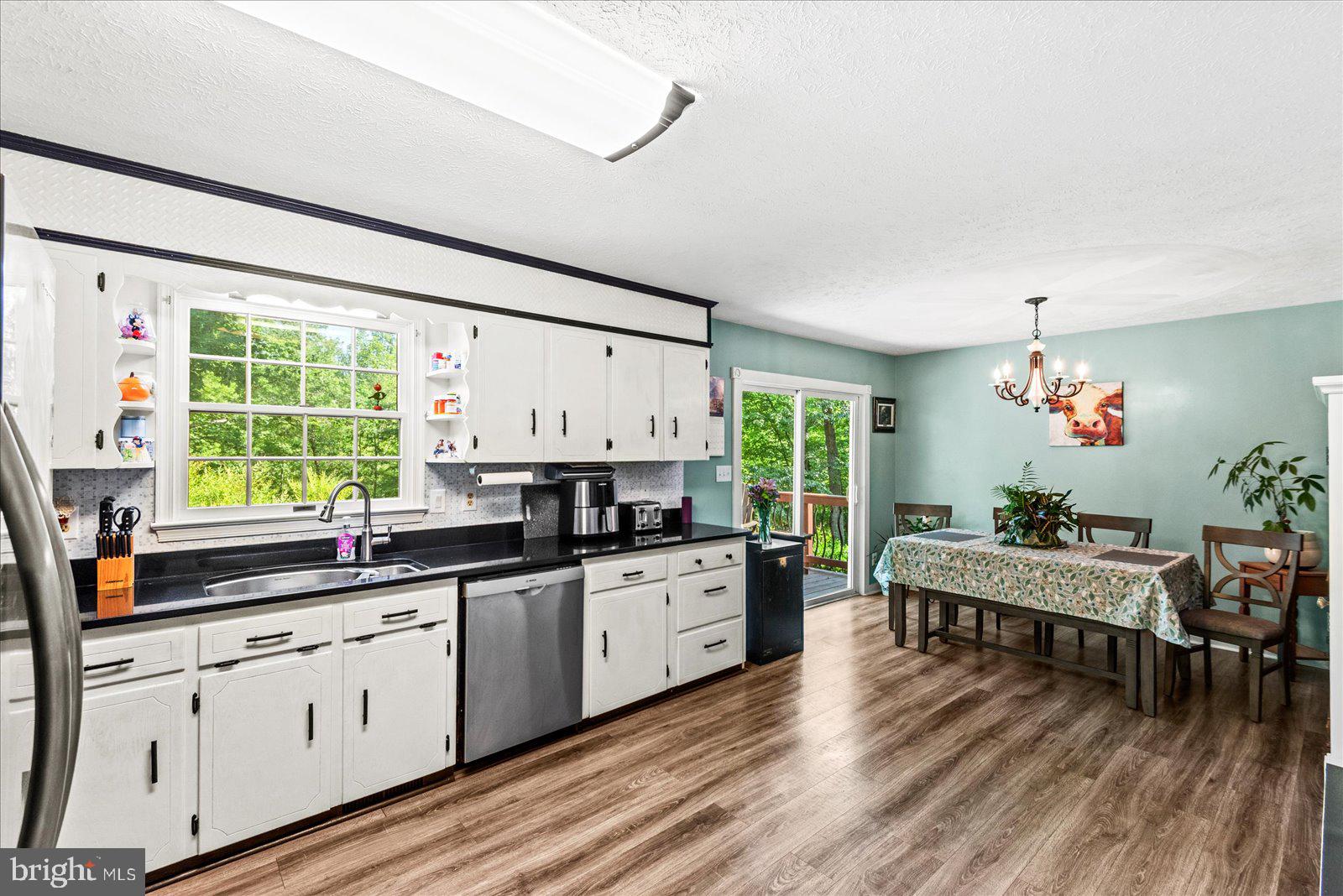 804 Buggy Lane Rochelle, VA 22738 - Photo 15 of 50 a kitchen with a sink stove and wooden floor