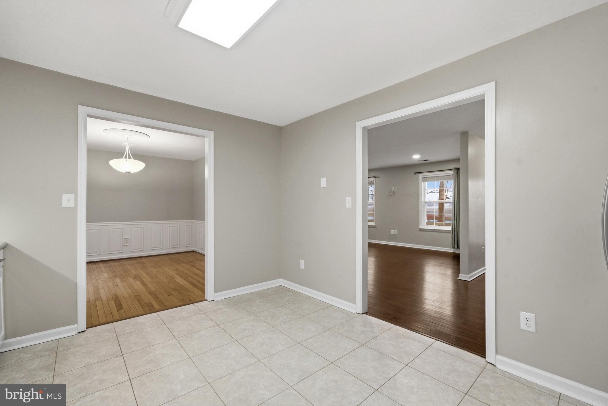 22343 Newtowne Neck Road Leonardtown, MD 20650 - Photo 14 of 40 a view of a hallway with wooden floor and a bathroom