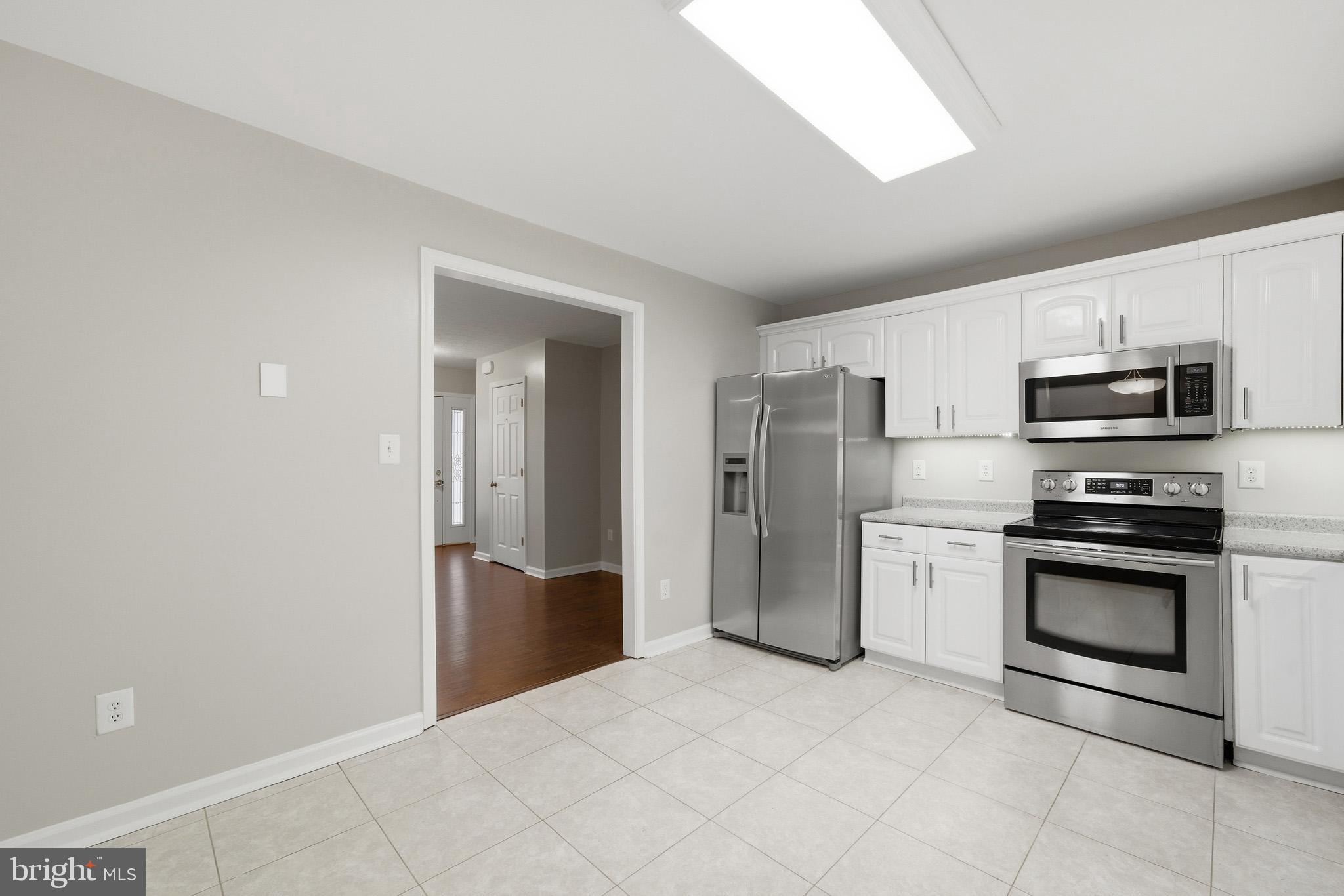 22343 Newtowne Neck Road Leonardtown, MD 20650 - Photo 15 of 40 a kitchen with stainless steel appliances granite countertop a refrigerator and a stove top oven