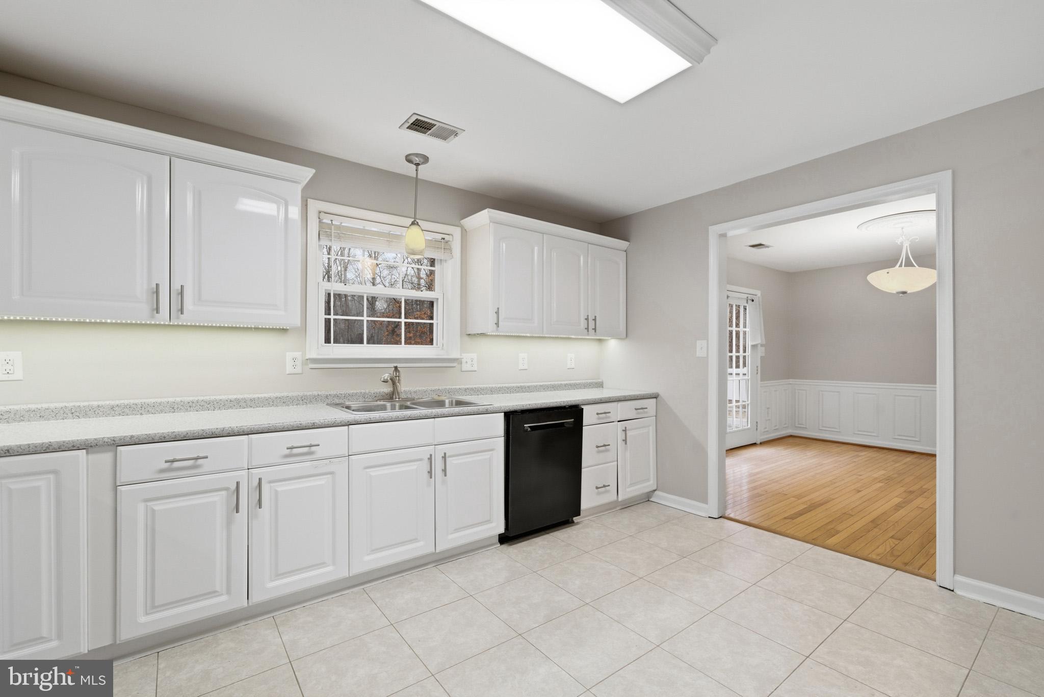 22343 Newtowne Neck Road Leonardtown, MD 20650 - Photo 18 of 40 a large white kitchen with granite countertop a sink