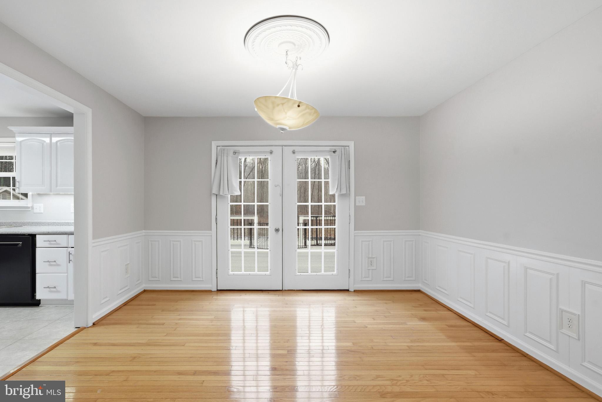 22343 Newtowne Neck Road Leonardtown, MD 20650 - Photo 19 of 40 a view of an empty room with a window and wooden floor