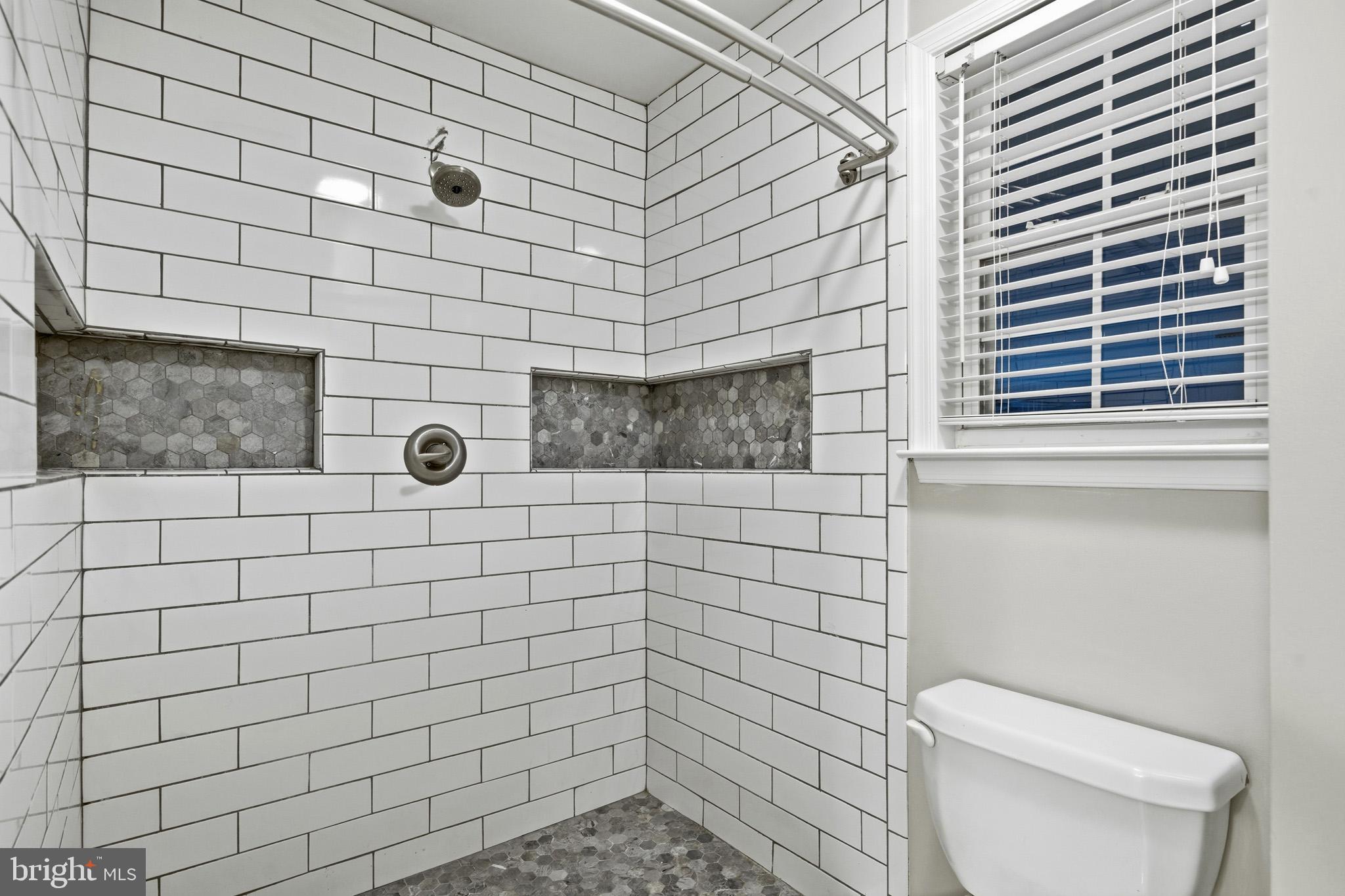 22343 Newtowne Neck Road Leonardtown, MD 20650 - Photo 28 of 40 a bathroom with a toilet and a shower