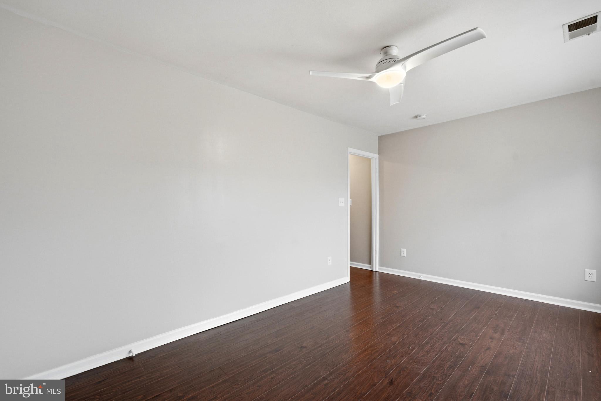 22343 Newtowne Neck Road Leonardtown, MD 20650 - Photo 29 of 40 an empty room with wooden floor and fan