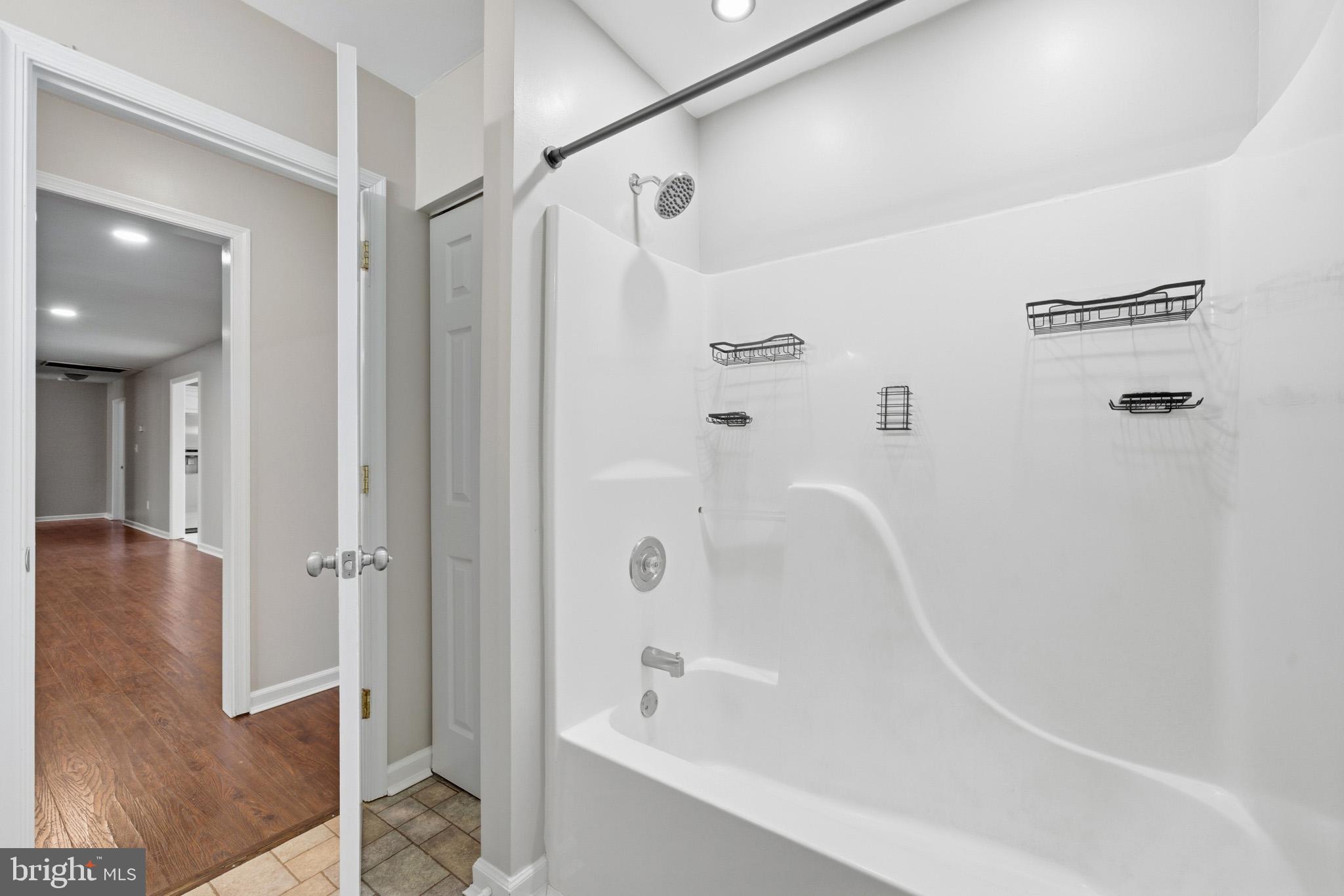 22343 Newtowne Neck Road Leonardtown, MD 20650 - Photo 32 of 40 a bathroom with a bathtub and a shower