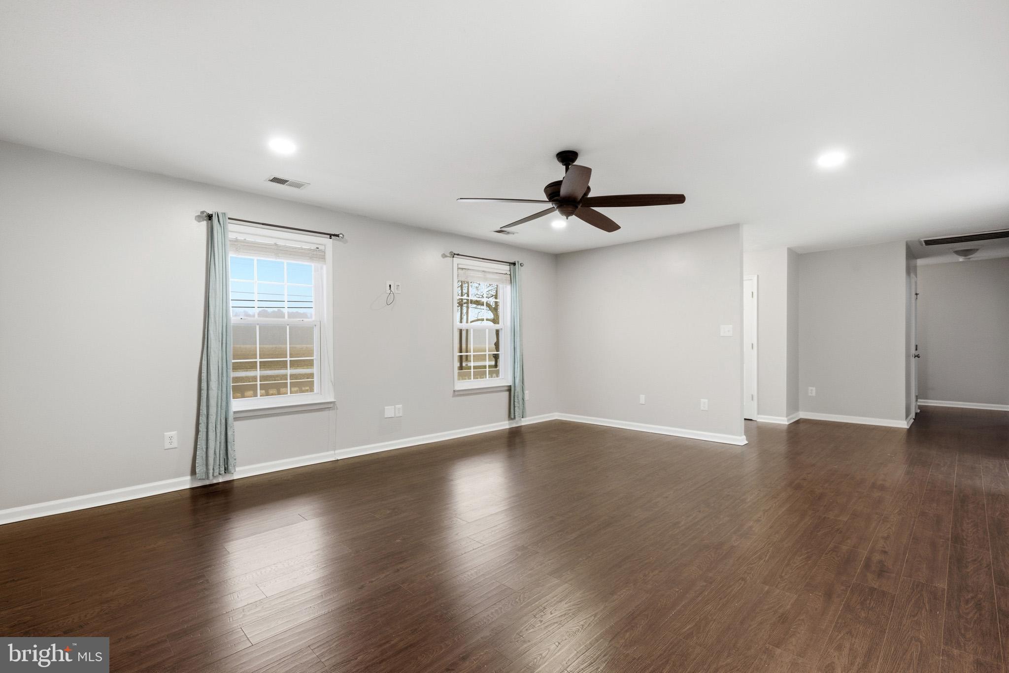 22343 Newtowne Neck Road Leonardtown, MD 20650 - Photo 8 of 40 a view of empty room with wooden floor and fan