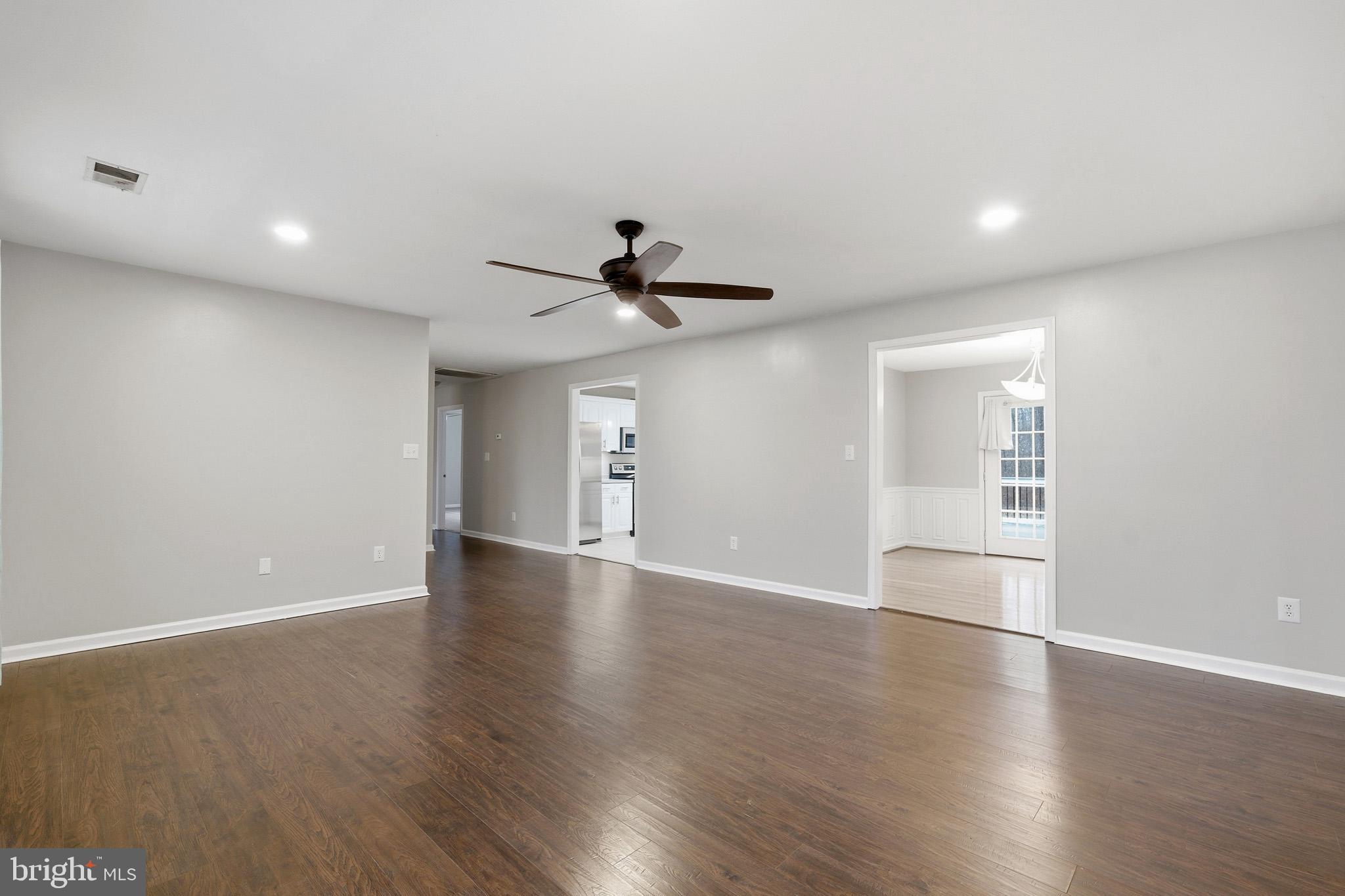 22343 Newtowne Neck Road Leonardtown, MD 20650 - Photo 9 of 40 a view of empty room with wooden floor and fan