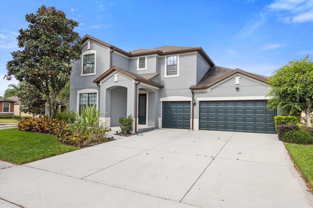 a front view of a house with a garden
