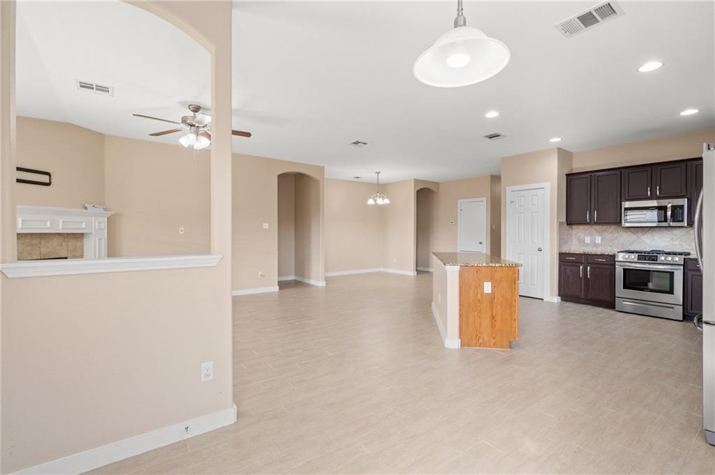 20224 Merlin Falcon Trail Pflugerville, TX 78660 - Photo 40 of 40 An open floorplan seamlessly connects the kitchen to a spacious living area, ideal for entertaining.
