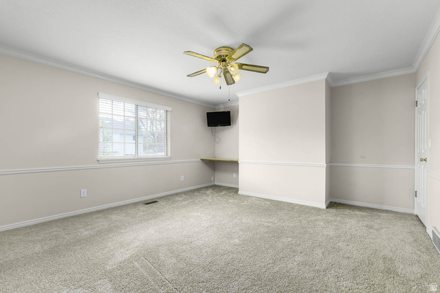 1822 East 9800th Street South Sandy, UT 84092 - Photo 22 of 38 Empty room featuring carpet, a ceiling fan, and ornamental molding