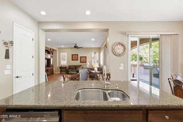 a bedroom with a bed a chandelier and mirror