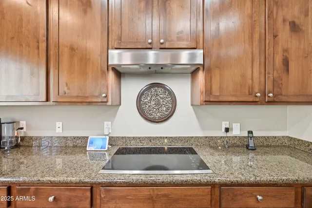 a bedroom with a bed and a flat tv screen on dresser