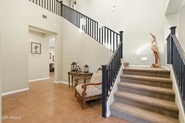 a view of a dining room with furniture a kitchen and chandelier