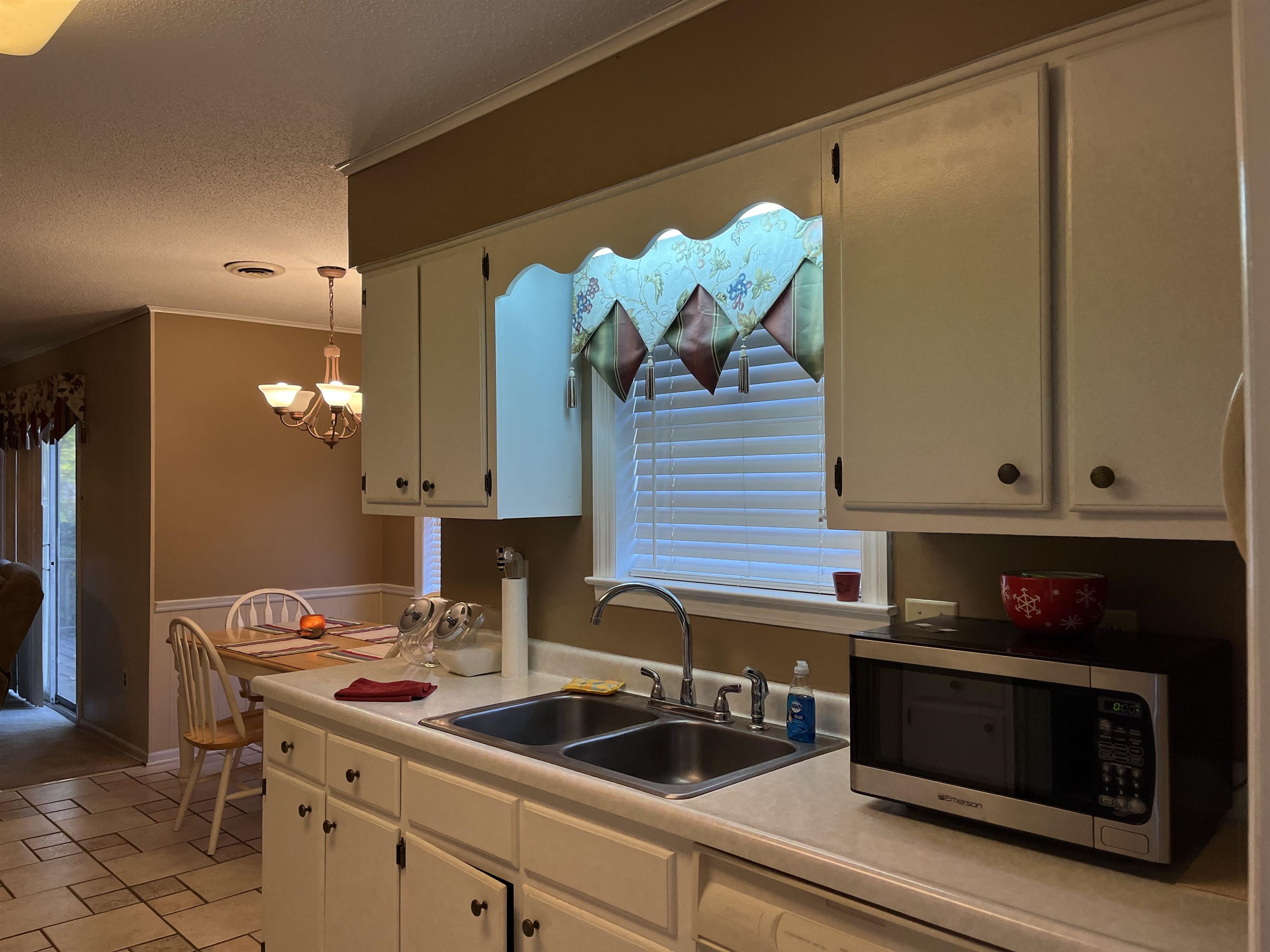 3045 Altruria Road Bartlett, TN 38134 - Photo 11 of 24 a kitchen with a sink cabinets and a wooden floor