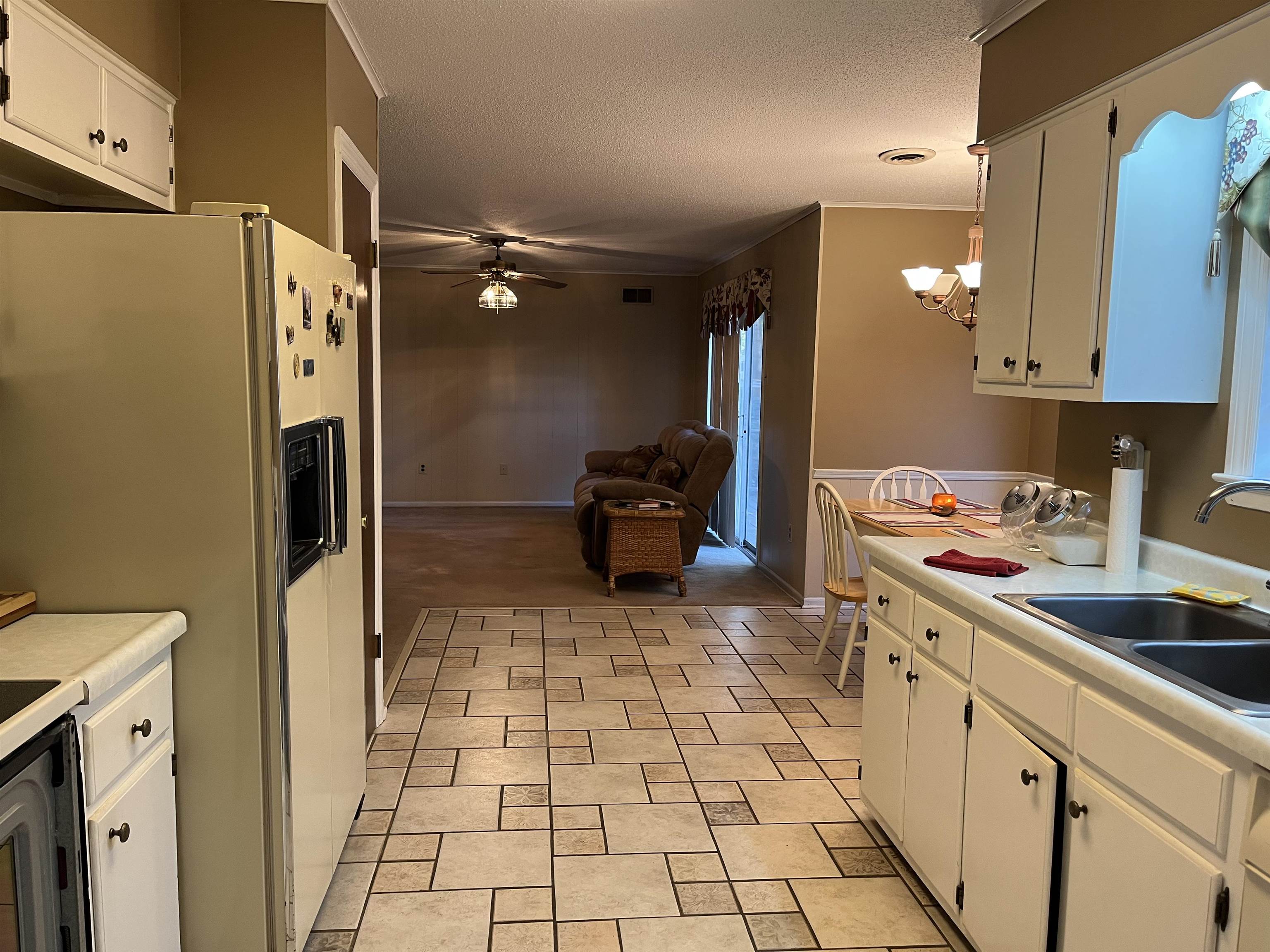 3045 Altruria Road Bartlett, TN 38134 - Photo 4 of 24 a kitchen with a sink a refrigerator and cabinets