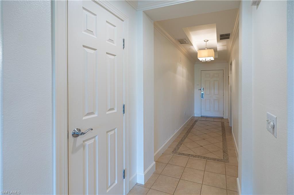 1362 Centre Ct Ridge Drive, Unit 101 Reunion, FL 34747 - Photo 4 of 25 Hall featuring crown molding and light tile floors