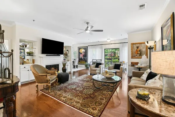 a living room with fireplace furniture and a flat screen tv