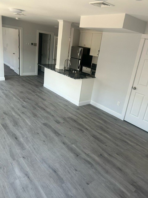 75 Wharf Street, Unit 202 Salem, MA 01970 - Photo 2 of 13 a view of a kitchen with wooden floor and electronic appliances